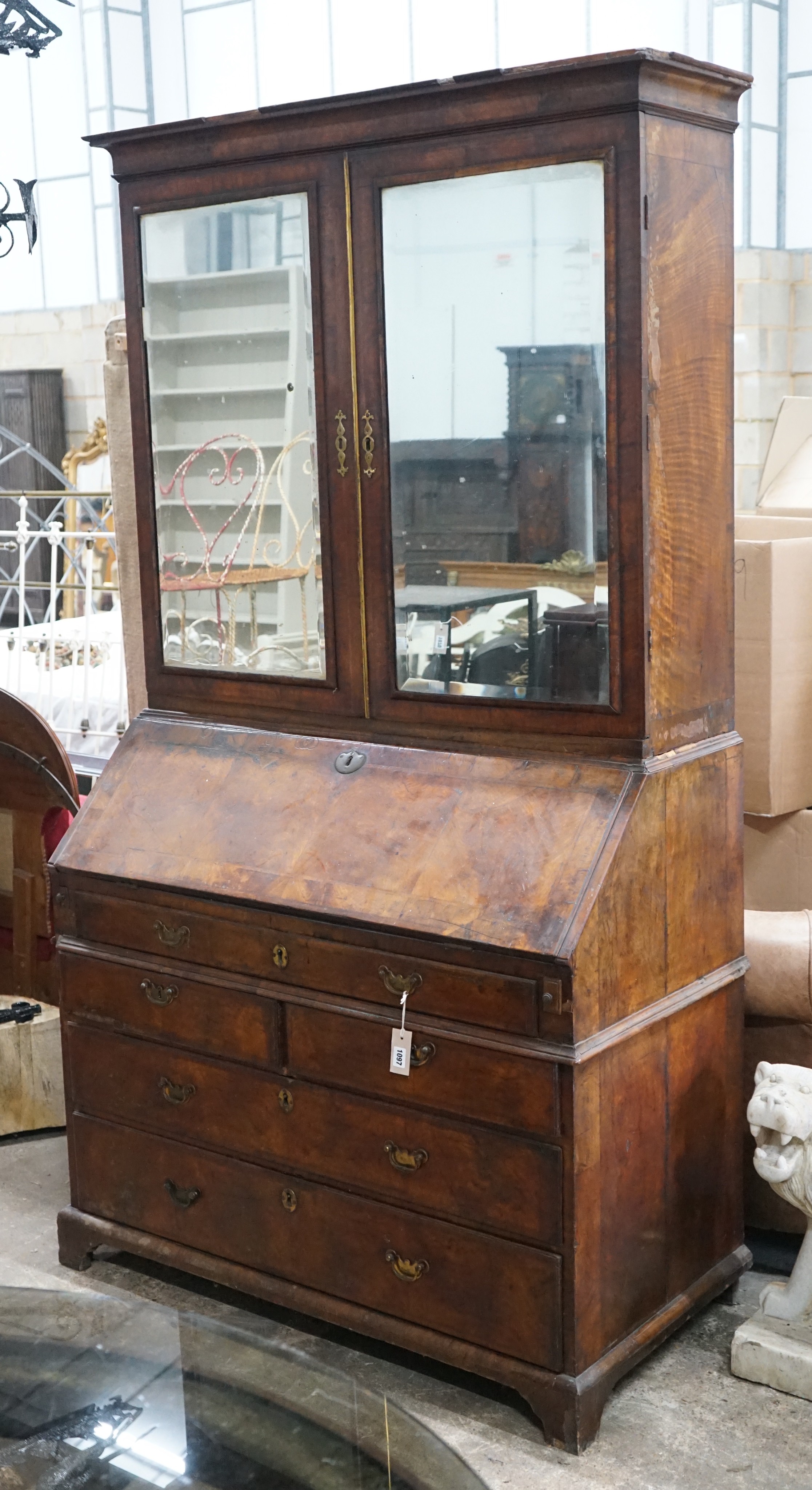 A mid 18th century feather banded figured walnut bureau cabinet, width 111cm, depth 57cm, height 207cm